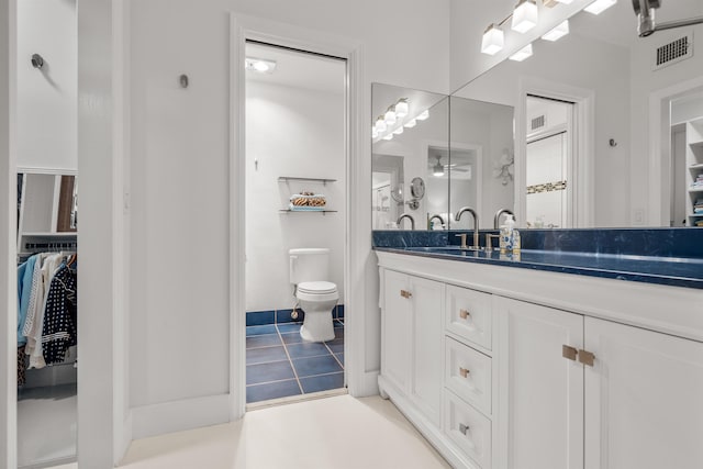 101 Dolphin Dr, Saint Augustine, FL 32080 - full bathroom featuring tile patterned flooring, vanity, a spacious closet, toilet, and visible vents