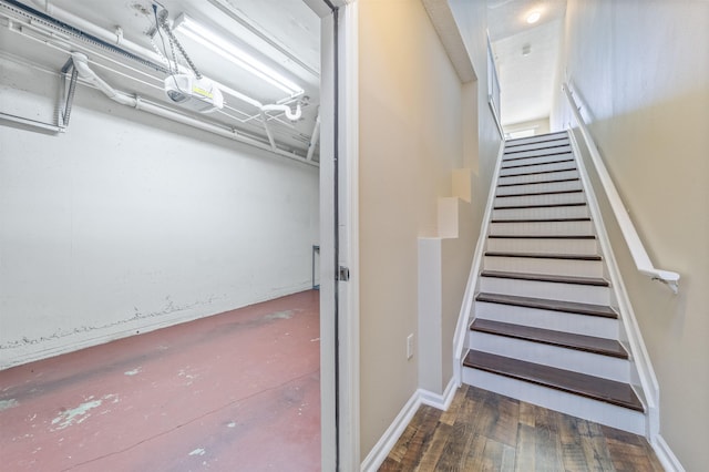 stairs featuring wood finished floors and baseboards