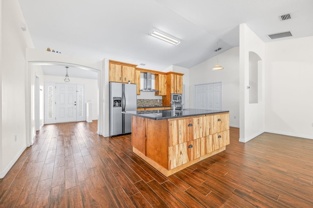 17 Porter Ln, Palm Coast, FL 32164 - kitchen featuring stainless steel appliances, arched walkways, wall chimney exhaust hood, dark countertops, and baseboards
