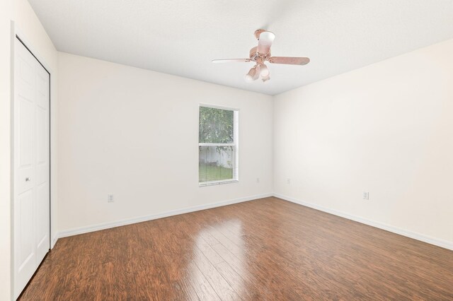 17 Porter Ln, Palm Coast, FL 32164 - unfurnished bedroom with wood finished floors, baseboards, a ceiling fan, and a closet