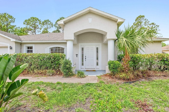 17 Porter Ln, Palm Coast, FL 32164 - property entrance featuring stucco siding