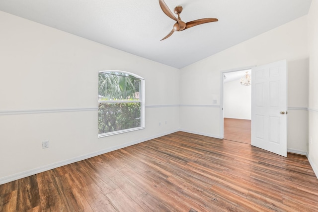 17 Porter Ln, Palm Coast, FL 32164 - spare room with vaulted ceiling, a ceiling fan, wood finished floors, a chandelier, and baseboards