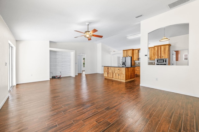 17 Porter Ln, Palm Coast, FL 32164 - unfurnished living room with dark wood finished floors, ceiling fan, vaulted ceiling, baseboards, and arched walkways