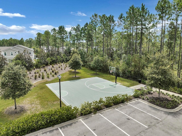 view of sport court featuring a yard