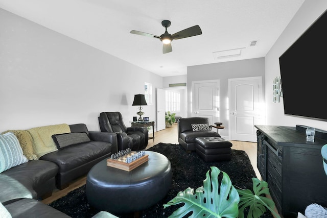 living room with ceiling fan and light hardwood / wood-style flooring