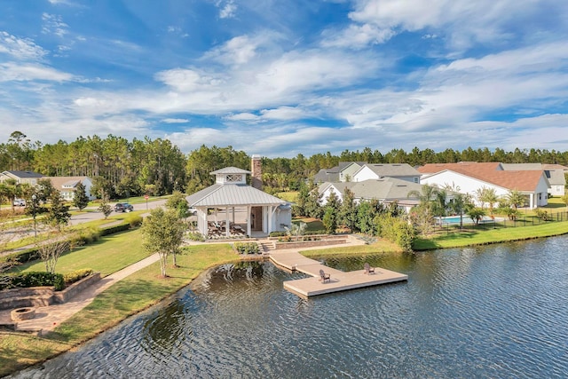 exterior space featuring a gazebo, a yard, and a water view