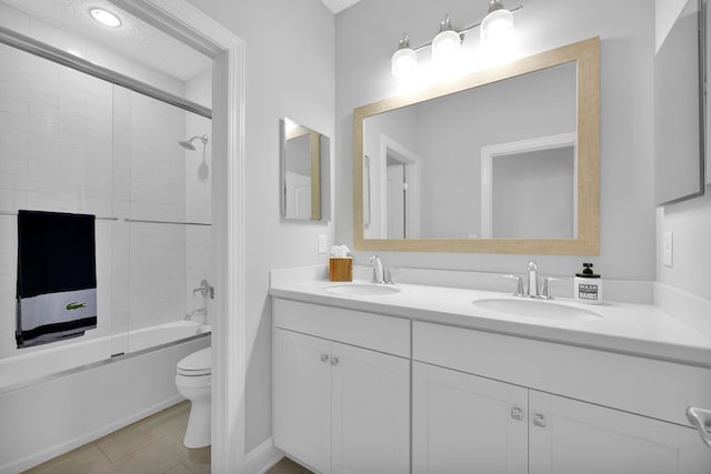 full bathroom featuring toilet, enclosed tub / shower combo, and vanity