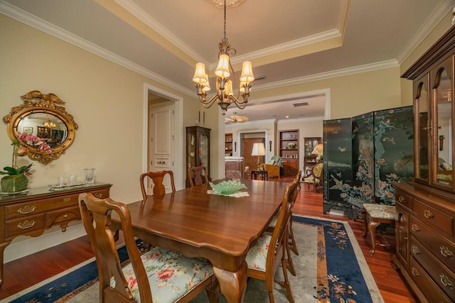485 Ocean Forest Dr, Saint Augustine, FL 32080 - dining room featuring a notable chandelier, wood finished floors, ornamental molding, and a raised ceiling