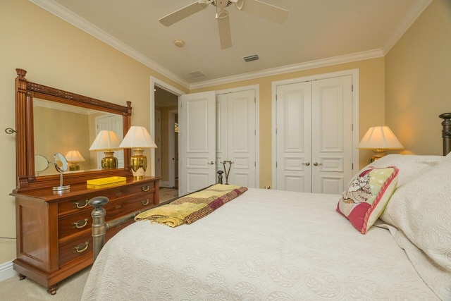 485 Ocean Forest Dr, Saint Augustine, FL 32080 - carpeted bedroom with crown molding, ceiling fan, visible vents, and two closets
