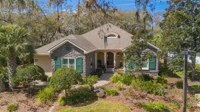 485 Ocean Forest Dr, Saint Augustine, FL 32080 - view of front of house with stone siding, stucco siding, and a shingled roof