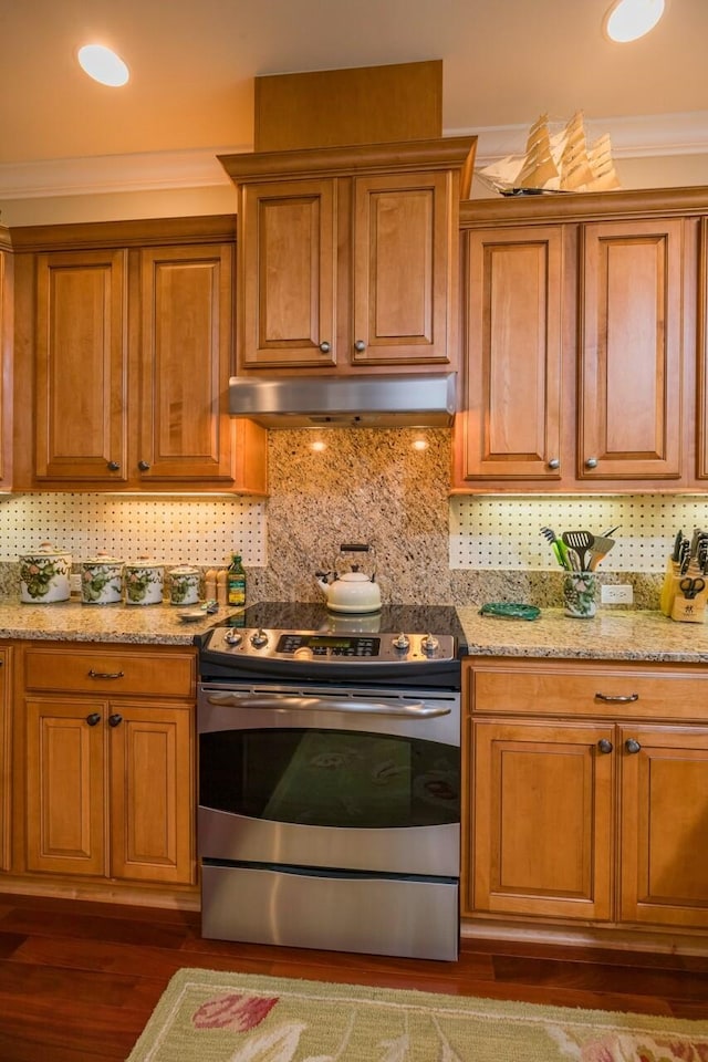 485 Ocean Forest Dr, Saint Augustine, FL 32080 - kitchen featuring under cabinet range hood, brown cabinets, backsplash, and stainless steel electric stove