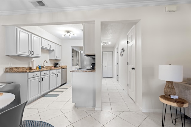 kitchen featuring visible vents, ornamental molding, a sink, stainless steel dishwasher, and light tile patterned floors