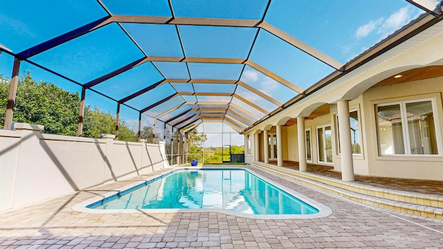 view of swimming pool with a patio and a lanai