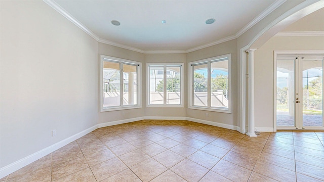 spare room with plenty of natural light, light tile patterned floors, and crown molding