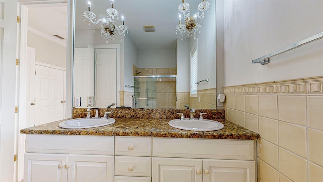 bathroom featuring vanity, an enclosed shower, and tile walls