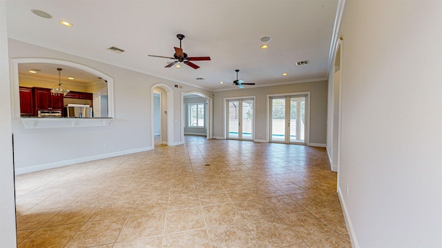 unfurnished living room featuring light tile patterned floors, french doors, ceiling fan, and ornamental molding