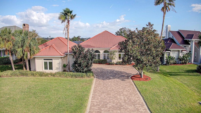 mediterranean / spanish-style home with a front lawn