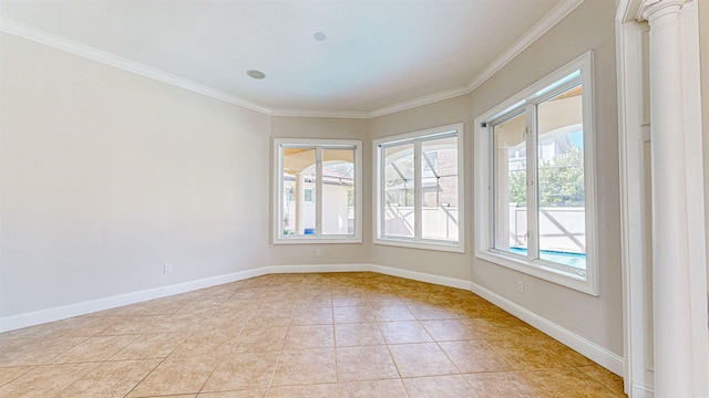 tiled spare room featuring crown molding