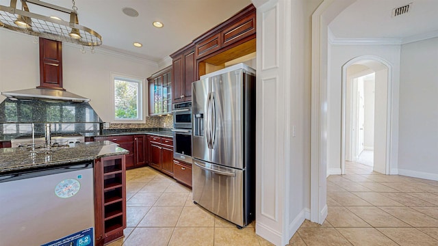 kitchen with decorative backsplash, light tile patterned floors, ornamental molding, and appliances with stainless steel finishes