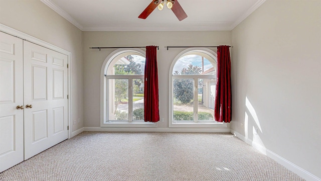 interior space with crown molding, ceiling fan, and a healthy amount of sunlight