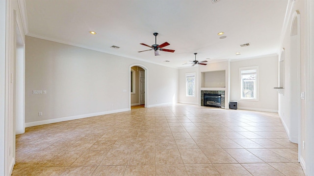 unfurnished living room featuring light tile patterned floors, ceiling fan, and crown molding