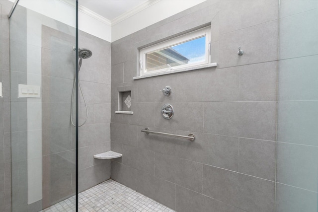 full bathroom with a tile shower and ornamental molding