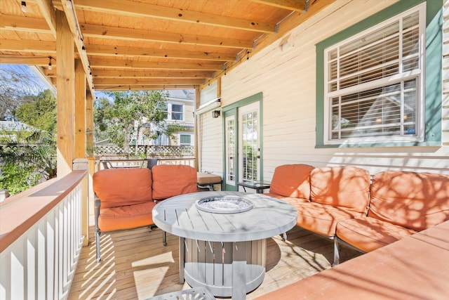 deck featuring an outdoor living space with a fire pit