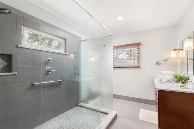 bathroom with a wealth of natural light, ornamental molding, and a tile shower