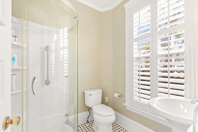 bathroom with a stall shower, toilet, baseboards, and ornamental molding