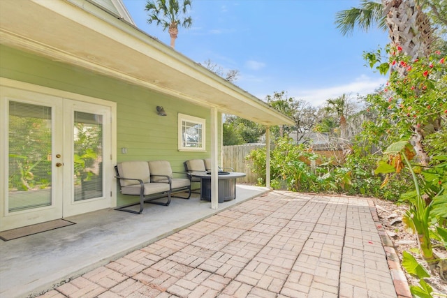 view of patio with french doors and fence