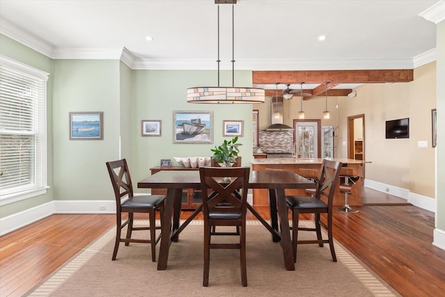 dining room featuring recessed lighting, wood finished floors, baseboards, and ornamental molding