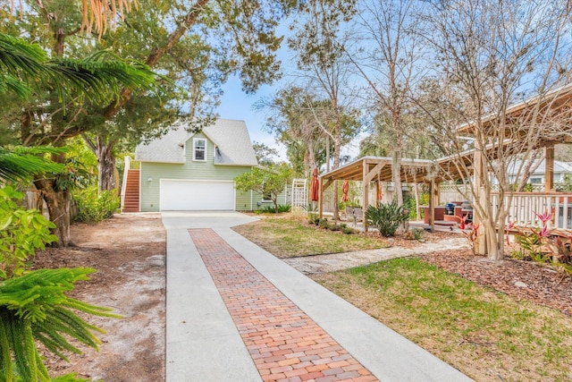 exterior space featuring driveway, stairs, and fence