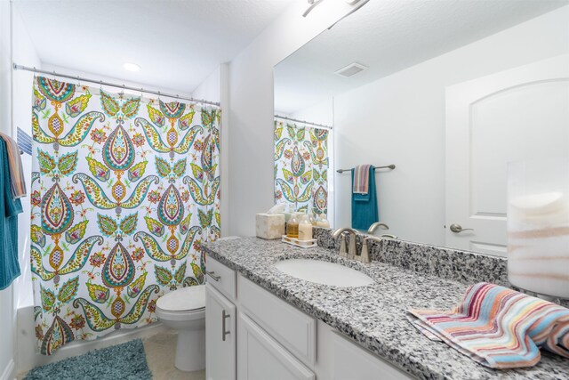 full bathroom with vanity, visible vents, toilet, shower / tub combo, and tile patterned floors