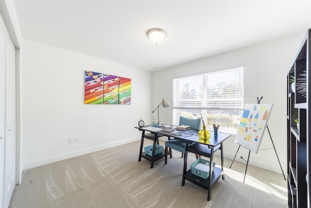 carpeted home office with baseboards