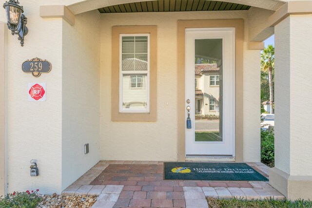 mediterranean / spanish-style home featuring a tiled roof, an attached garage, cooling unit, stucco siding, and decorative driveway