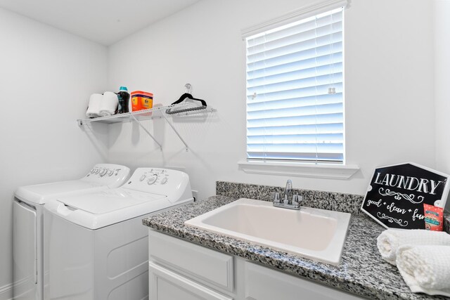 clothes washing area featuring a sink and washing machine and clothes dryer