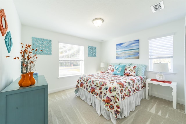 bedroom featuring multiple windows, visible vents, and carpet floors