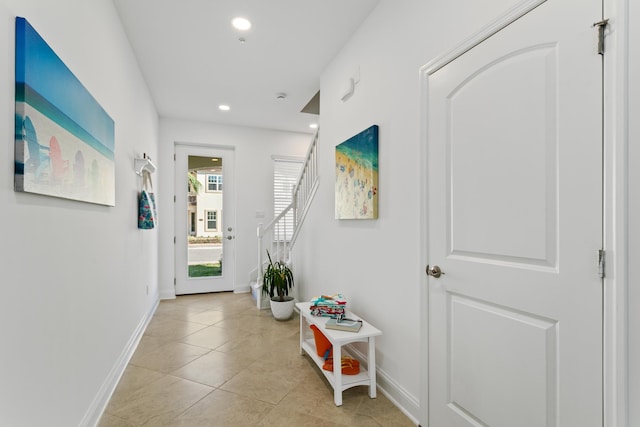 interior space with light tile patterned flooring, baseboards, stairway, and recessed lighting