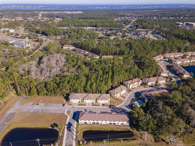 drone / aerial view featuring a water view and a view of trees