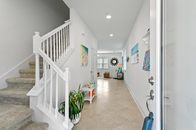 interior space featuring light tile patterned floors, baseboards, recessed lighting, and stairway
