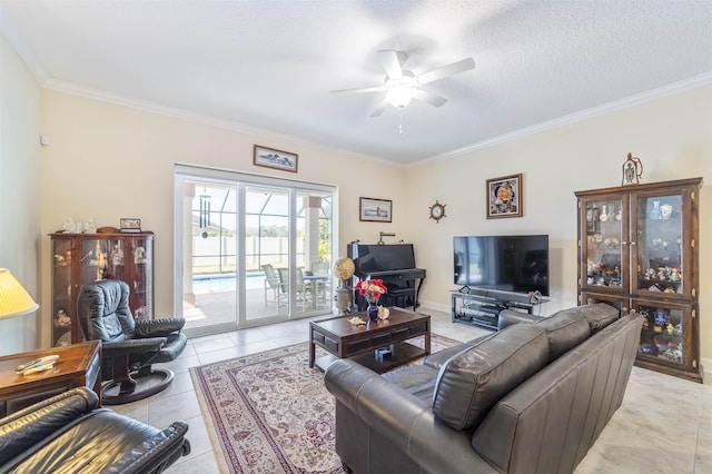 living room with a textured ceiling, ceiling fan, light tile patterned flooring, and crown molding