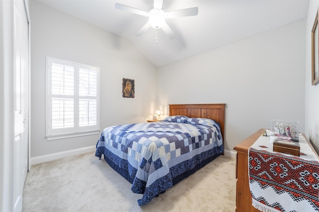 bedroom featuring light carpet, baseboards, a ceiling fan, and lofted ceiling