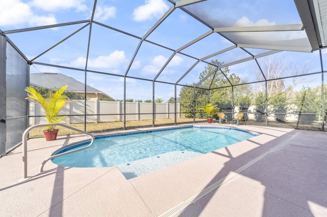 view of pool featuring glass enclosure, a patio area, fence, and a fenced in pool