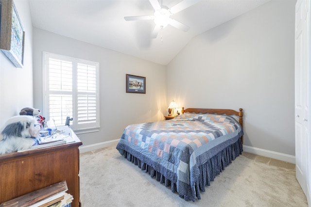 bedroom featuring light carpet, ceiling fan, lofted ceiling, and baseboards