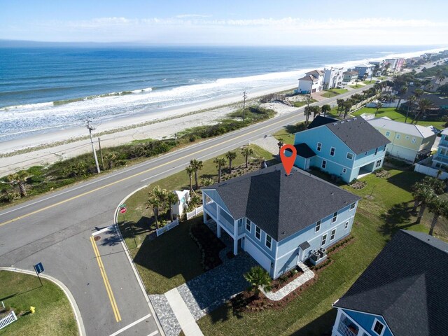 bird's eye view featuring a water view and a beach view