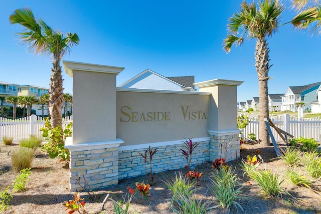 community sign featuring a residential view and fence