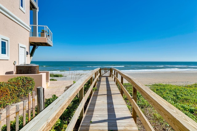 surrounding community featuring a water view and a view of the beach