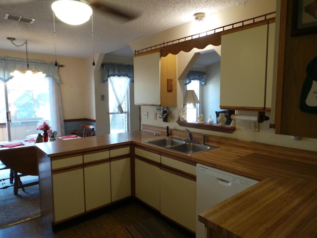 kitchen featuring white dishwasher, a textured ceiling, sink, kitchen peninsula, and ceiling fan