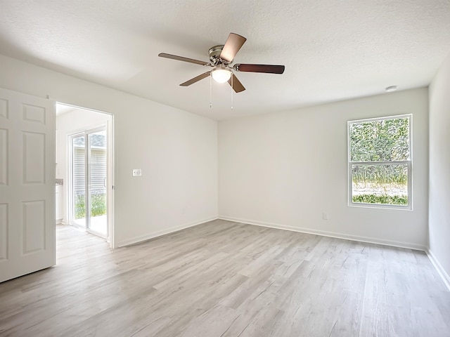 921 Helen St, Saint Augustine, FL 32084 - empty room featuring light wood-type flooring, healthy amount of natural light, ceiling fan, baseboards, and a textured ceiling