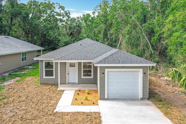 921 Helen St, Saint Augustine, FL 32084 - ranch-style house featuring roof with shingles, an attached garage, concrete driveway, and covered porch